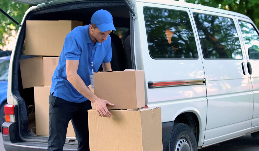 Delivery man unloading boxes from a van for efficient order delivery