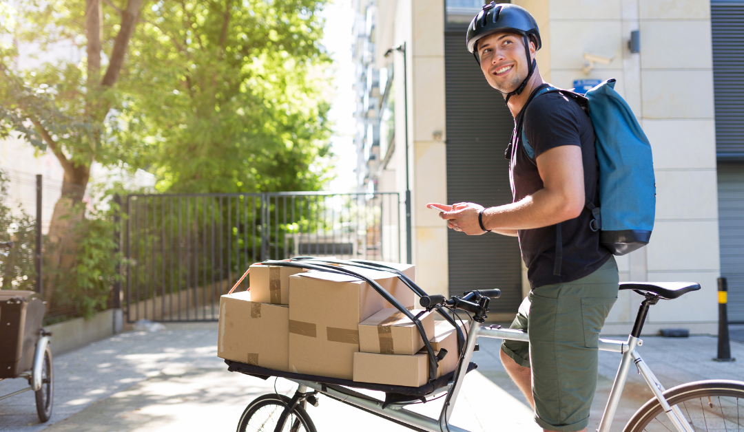 Bicycle courier navigating streets with a stack of delivery boxes, searching for an address.