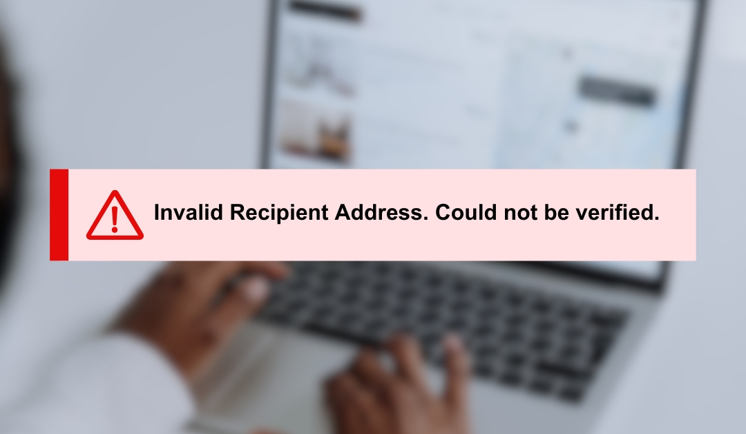 Invalid destination address notification in front of a blurred background of a computer screen