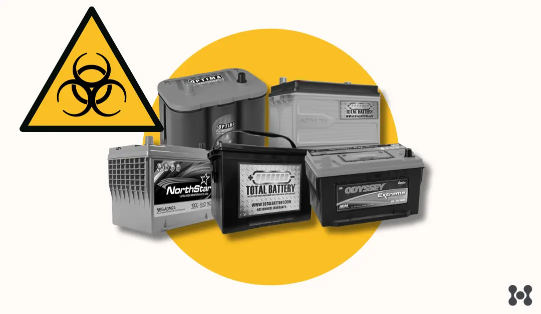 5 automotive batteries are shown in a stack. They are all different brands. In the top left corner there is a large black and yellow hazard sign.