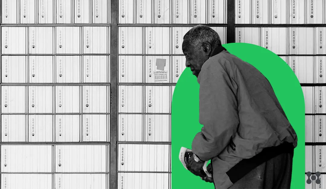 A man visits a PO Box. The image is in black and white with a bright green circle around the man standing in front of a row of PO Boxes that fill the entirety of the image background. 