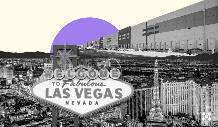 The background of the photo features a bright yellow background with a solid purple sun setting in the distance. In the foreground, there are black and white cutouts of the welcome to las vegas sign, as well as a large distribution center.